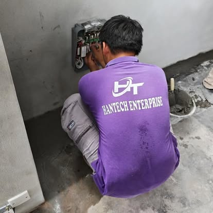 A HANTECH technician wiring a control panel on site