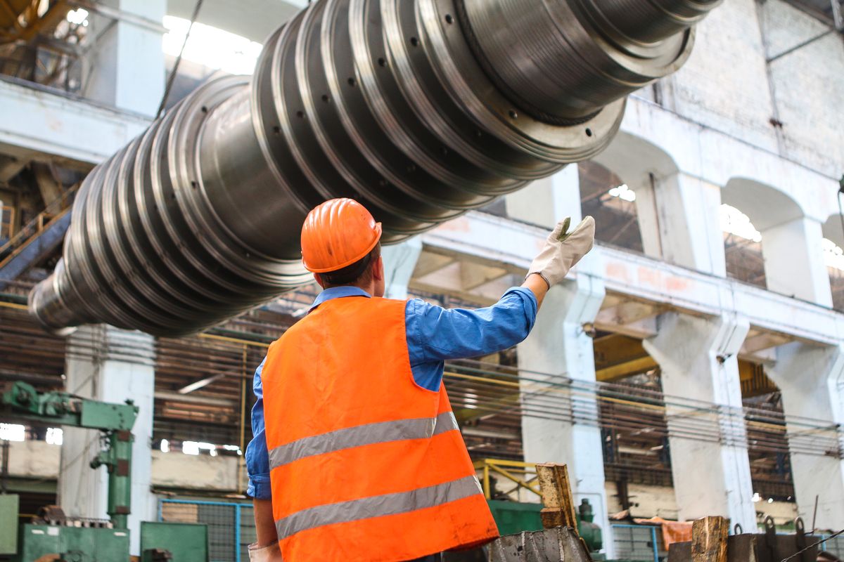 Technician assembling precision aerospace components in a clean factory