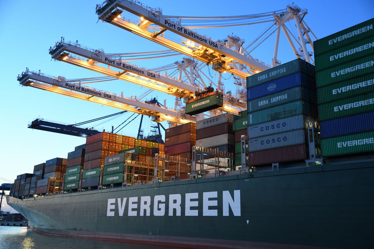 Containers stacked at a Johor port terminal with cranes