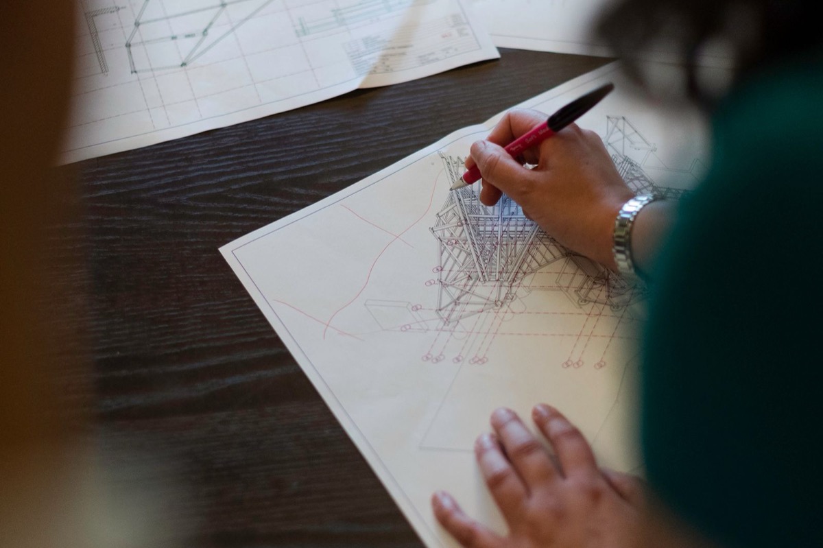 Engineers reviewing technical drawings at a desk