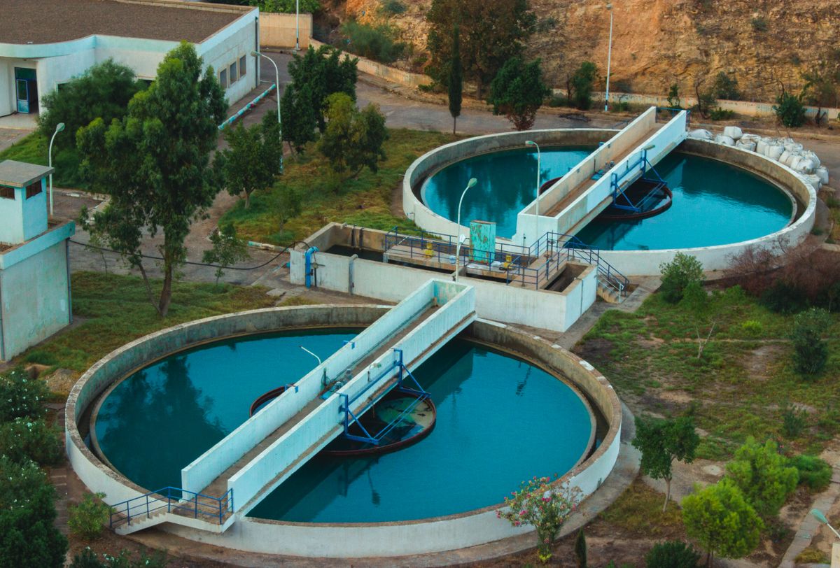 Aerial view of a water treatment plant with circular clarifier tanks